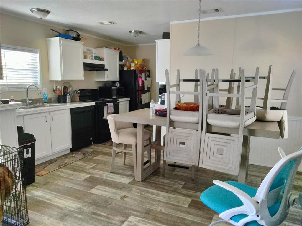 709 North Collins Freeway, Unit 70 Howe, TX 75459 - Photo 14 of 15 a kitchen with stainless steel appliances kitchen island granite countertop a table chairs microwave and sink