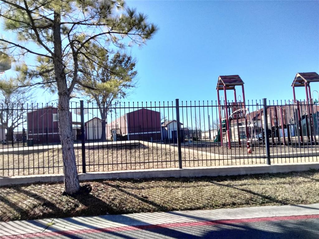 709 North Collins Freeway, Unit 70 Howe, TX 75459 - Photo 3 of 15 a view of a yard with wooden fence and large trees