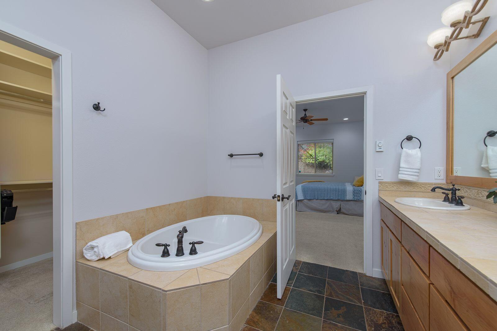 19442 Chip Shot Lane Bend, OR 97702 - Photo 23 of 47 Stone floors, soaking tub and walk in closet