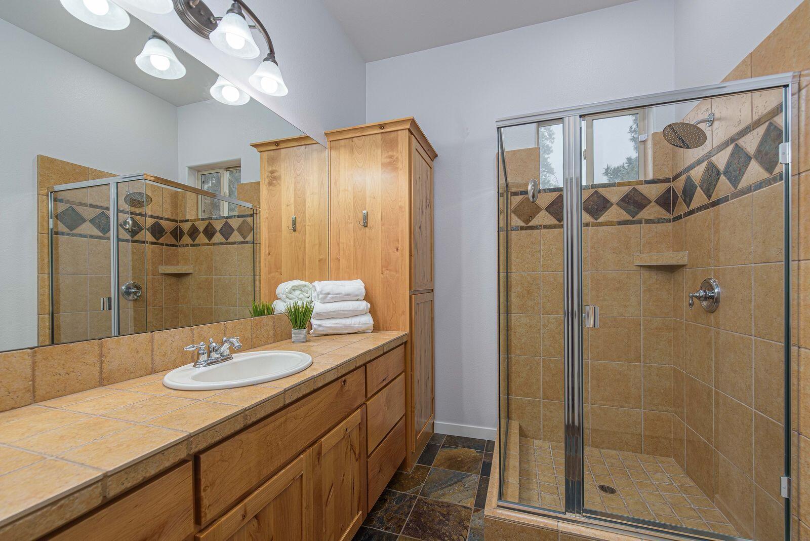19442 Chip Shot Lane Bend, OR 97702 - Photo 27 of 47 Walk in shower, dual sinks and an enclosed toilet area