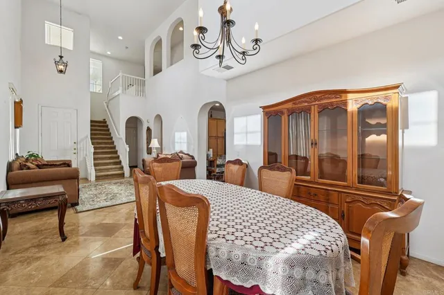 a living room with stainless steel appliances granite countertop furniture a couch and a view of kitchen