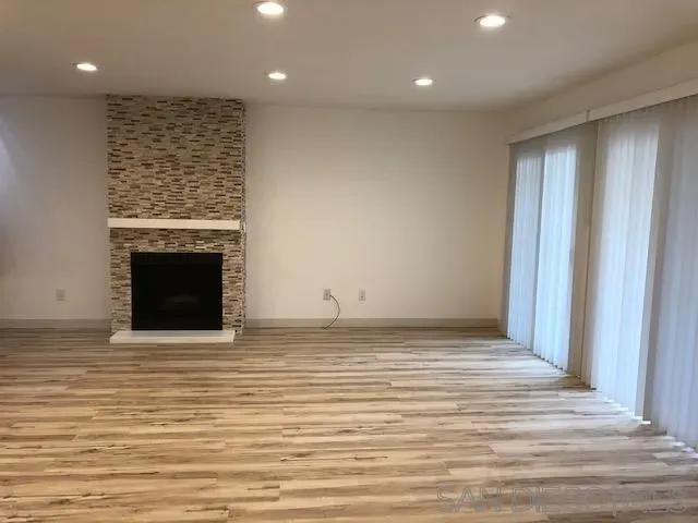 a view of an empty room with a fireplace