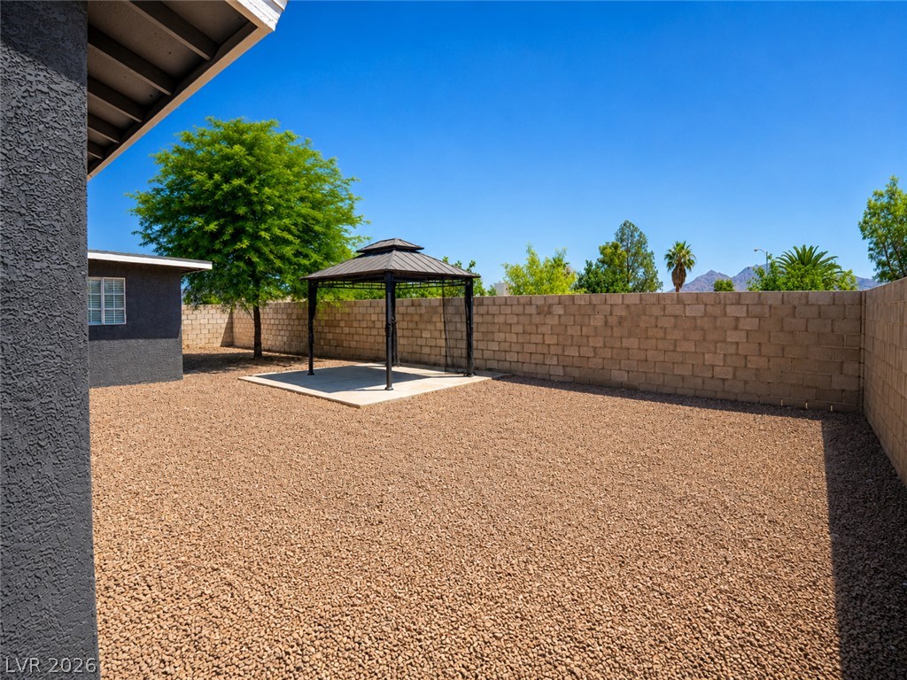 2870 South Sandhill Road Las Vegas, NV 89121 - Photo 14 of 64 A spacious yard features a gazebo, ideal for outdoor entertaining under the clear sky.