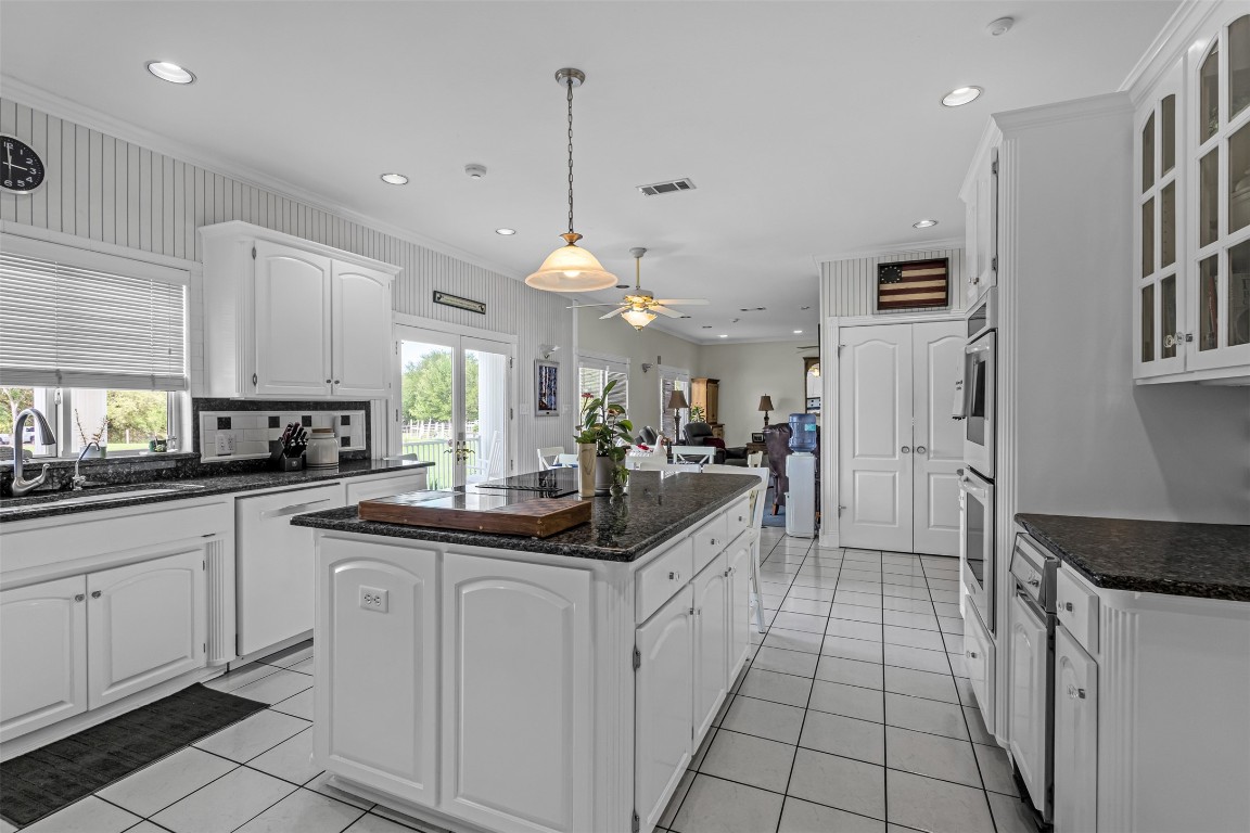 10299 Paddy Hamilton Road Belton, TX 76513 - Photo 16 of 39 a kitchen with white cabinets and sink