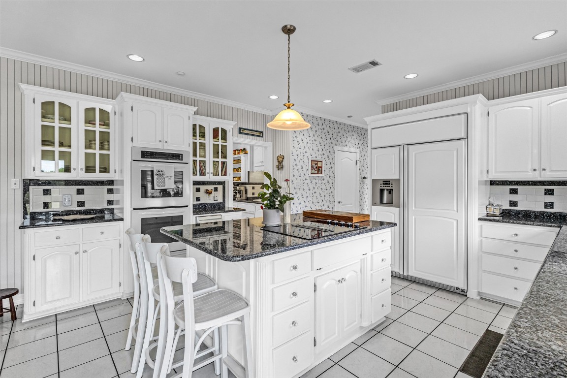 10299 Paddy Hamilton Road Belton, TX 76513 - Photo 18 of 39 a kitchen with stainless steel appliances kitchen island granite countertop a stove a sink and a refrigerator