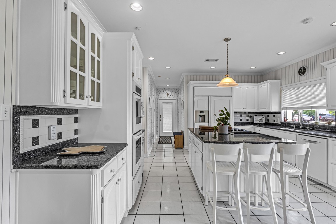 10299 Paddy Hamilton Road Belton, TX 76513 - Photo 19 of 39 a kitchen with stainless steel appliances granite countertop a stove and a cabinets