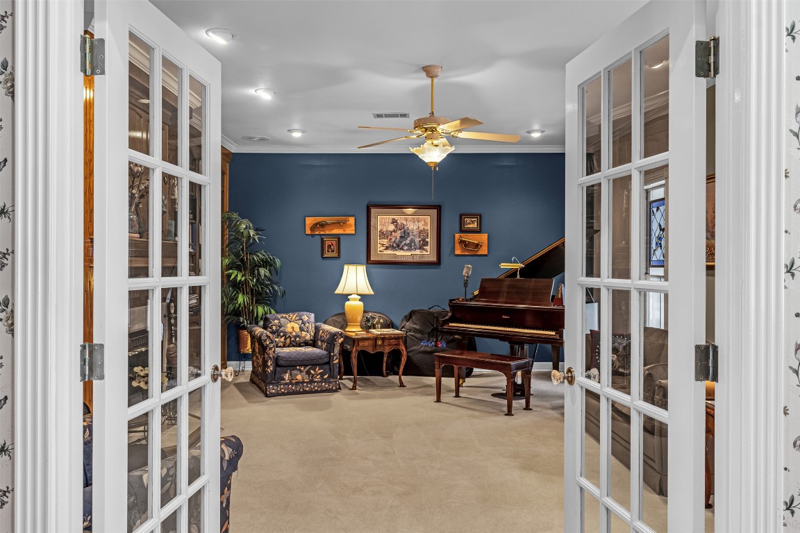 10299 Paddy Hamilton Road Belton, TX 76513 - Photo 24 of 39 a living room with furniture a chandelier and a flat screen tv