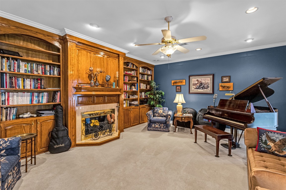10299 Paddy Hamilton Road Belton, TX 76513 - Photo 25 of 39 a living room with furniture a bookshelf and a flat screen tv