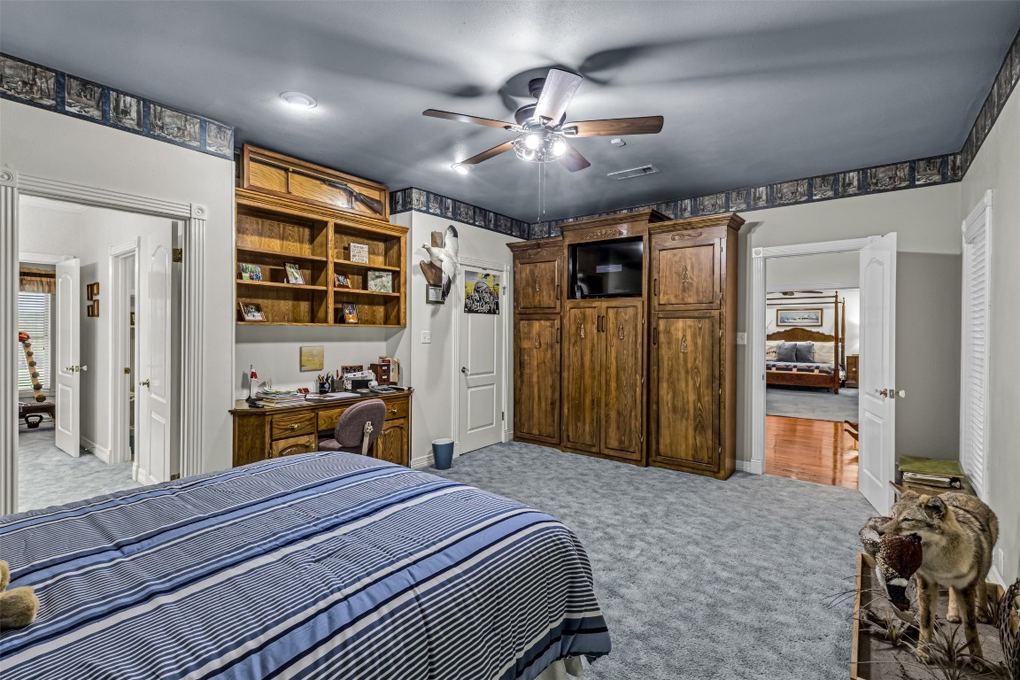 10299 Paddy Hamilton Road Belton, TX 76513 - Photo 34 of 39 a bedroom with a bed and a chandelier