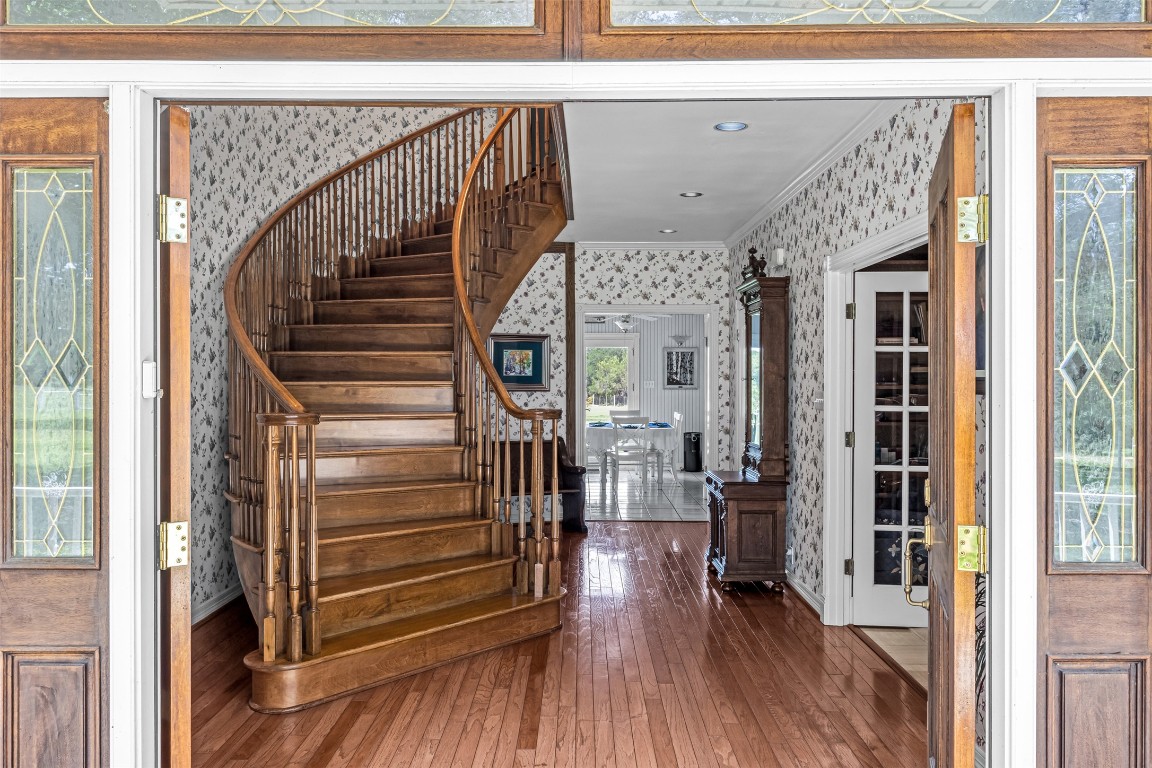 10299 Paddy Hamilton Road Belton, TX 76513 - Photo 10 of 39 a view of a hallway with wooden floor and staircase