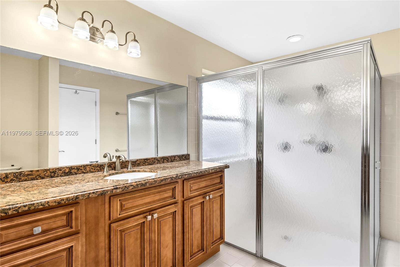 3562 Southern Orchard Road West Davie, FL 33328 - Photo 26 of 49 a bathroom with a granite countertop sink mirror and double