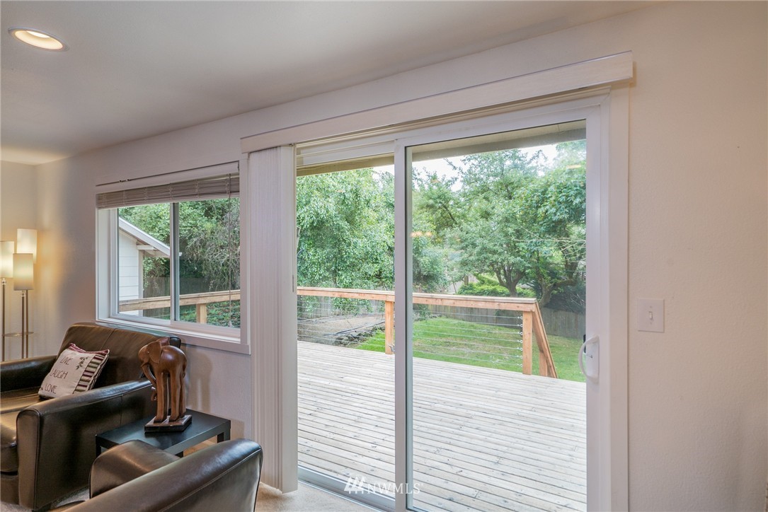 10215 Northeast 198th Street Bothell, WA 98011 - Photo 11 of 25 a living room with furniture and a floor to ceiling window
