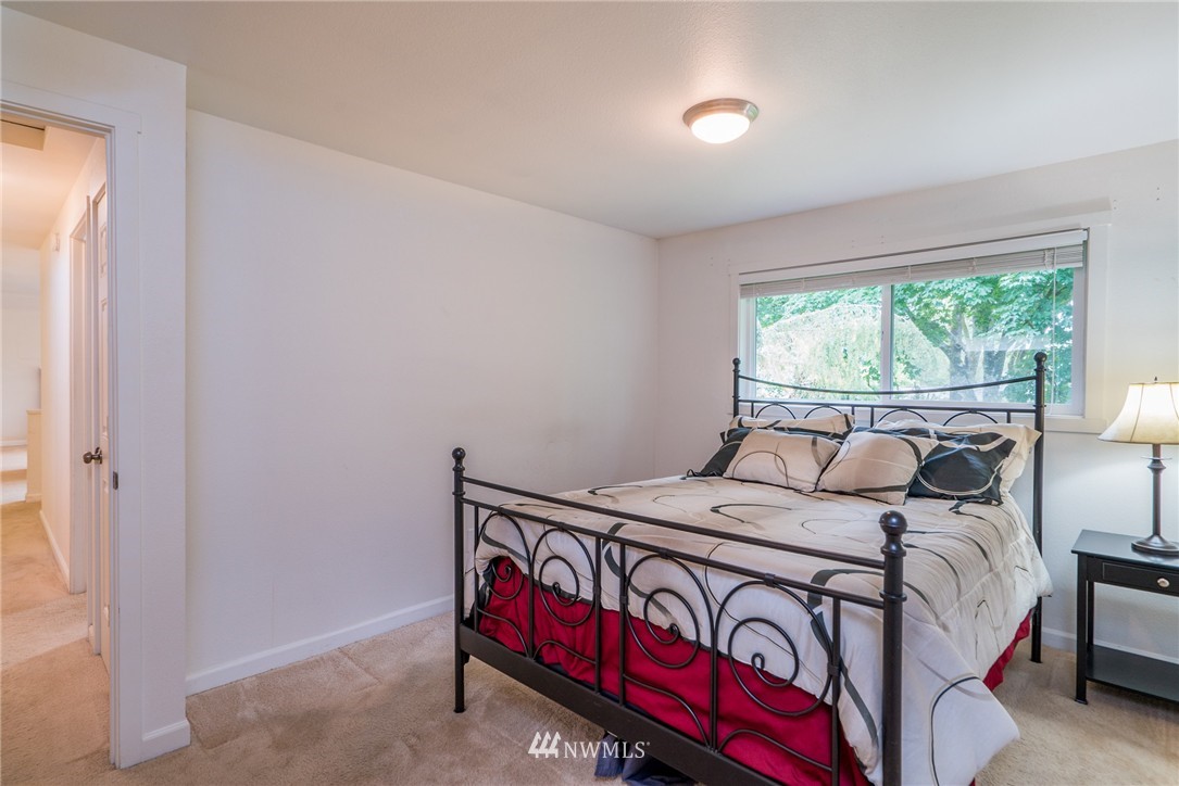 10215 Northeast 198th Street Bothell, WA 98011 - Photo 12 of 25 a bedroom with a bed and a window
