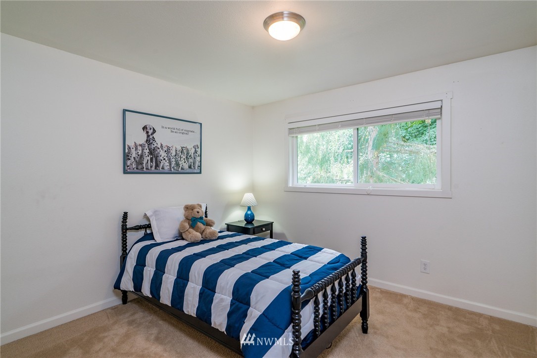 10215 Northeast 198th Street Bothell, WA 98011 - Photo 16 of 25 a bedroom with a bed and a window