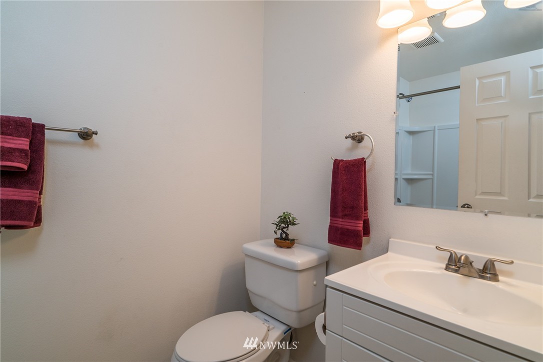 10215 Northeast 198th Street Bothell, WA 98011 - Photo 17 of 25 a bathroom with a sink mirror vanity and toilet