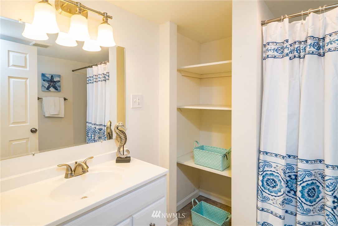 10215 Northeast 198th Street Bothell, WA 98011 - Photo 21 of 25 a bathroom with a sink and a mirror