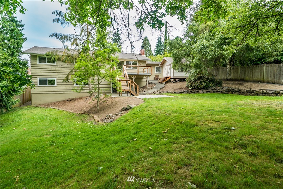 10215 Northeast 198th Street Bothell, WA 98011 - Photo 24 of 25 a view of a patio with a table and chairs under an umbrella