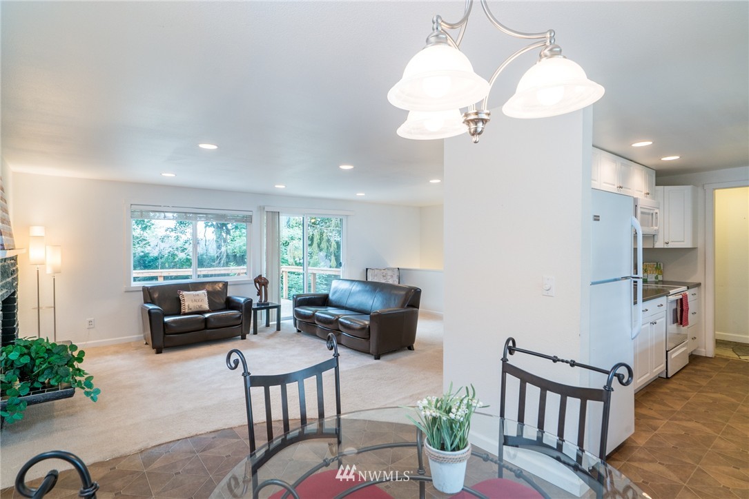 10215 Northeast 198th Street Bothell, WA 98011 - Photo 8 of 25 a living room with furniture a large window and a chandelier