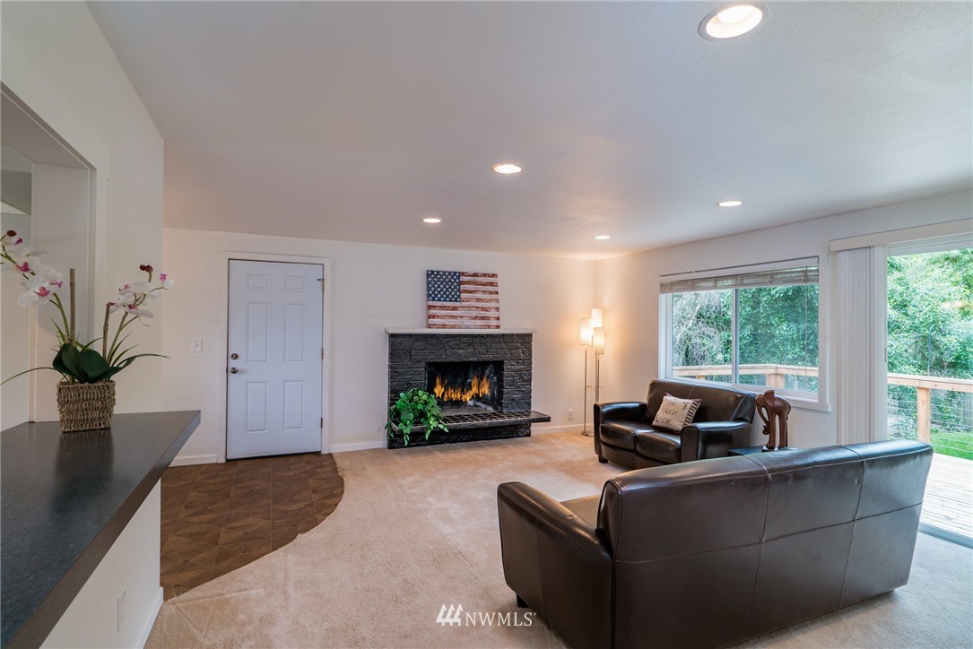 10215 Northeast 198th Street Bothell, WA 98011 - Photo 9 of 25 a living room with furniture and a fireplace