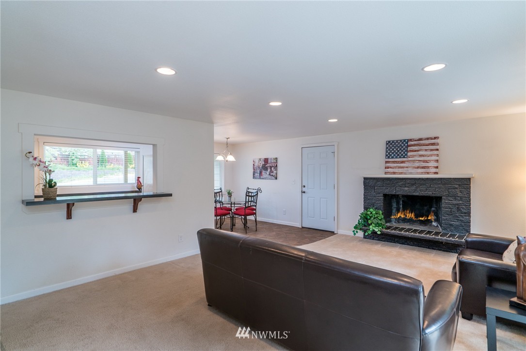 10215 Northeast 198th Street Bothell, WA 98011 - Photo 10 of 25 a living room with furniture and a fireplace