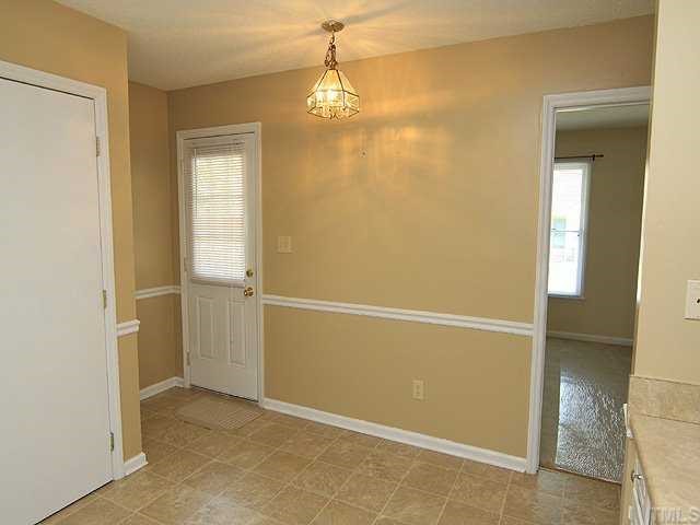 4125 Timberbrook Drive Raleigh, NC 27616 - Photo 6 of 12 an empty room with windows and entrance