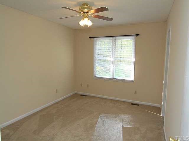4125 Timberbrook Drive Raleigh, NC 27616 - Photo 7 of 12 an empty room with a window and a fan