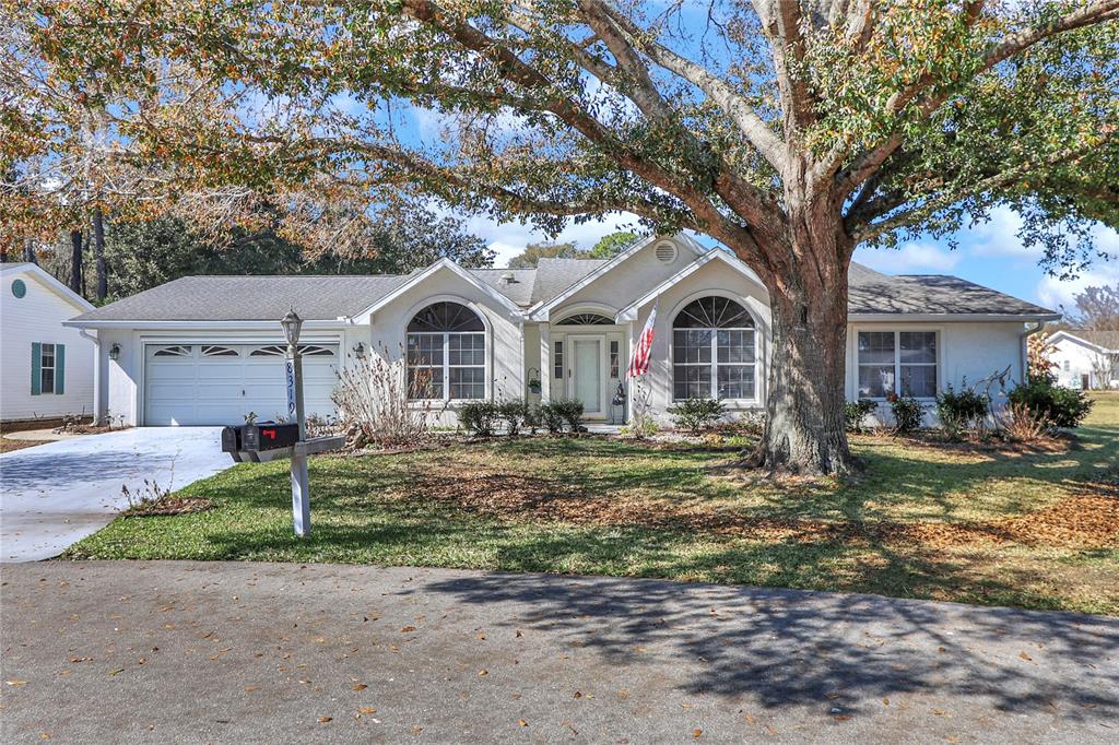 8319 Southwest 108th Loop Ocala, FL 34481 - Photo 1 of 27 a front view of a house with garden