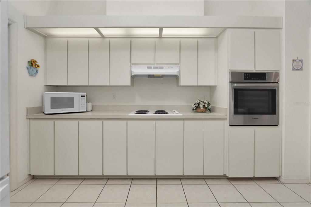 8319 Southwest 108th Loop Ocala, FL 34481 - Photo 11 of 27 a kitchen with white cabinets and stainless steel appliances