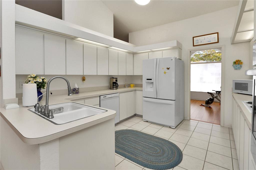 8319 Southwest 108th Loop Ocala, FL 34481 - Photo 12 of 27 a kitchen with a sink appliances and cabinets