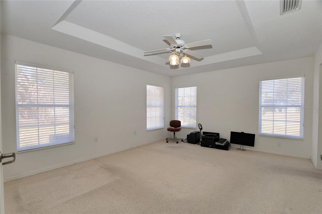 8319 Southwest 108th Loop Ocala, FL 34481 - Photo 15 of 27 a spacious bedroom with a bed and a window