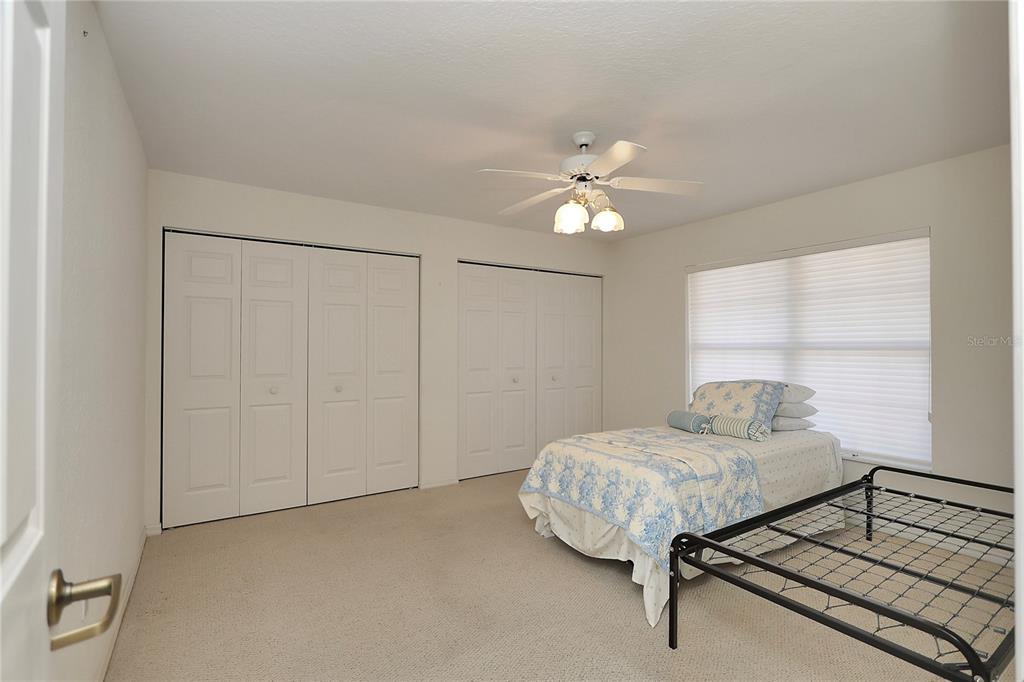 8319 Southwest 108th Loop Ocala, FL 34481 - Photo 18 of 27 a bedroom with a bed and a chandelier