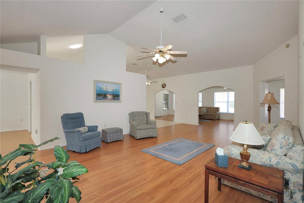 8319 Southwest 108th Loop Ocala, FL 34481 - Photo 7 of 27 a living room with furniture a lamp and a chandelier