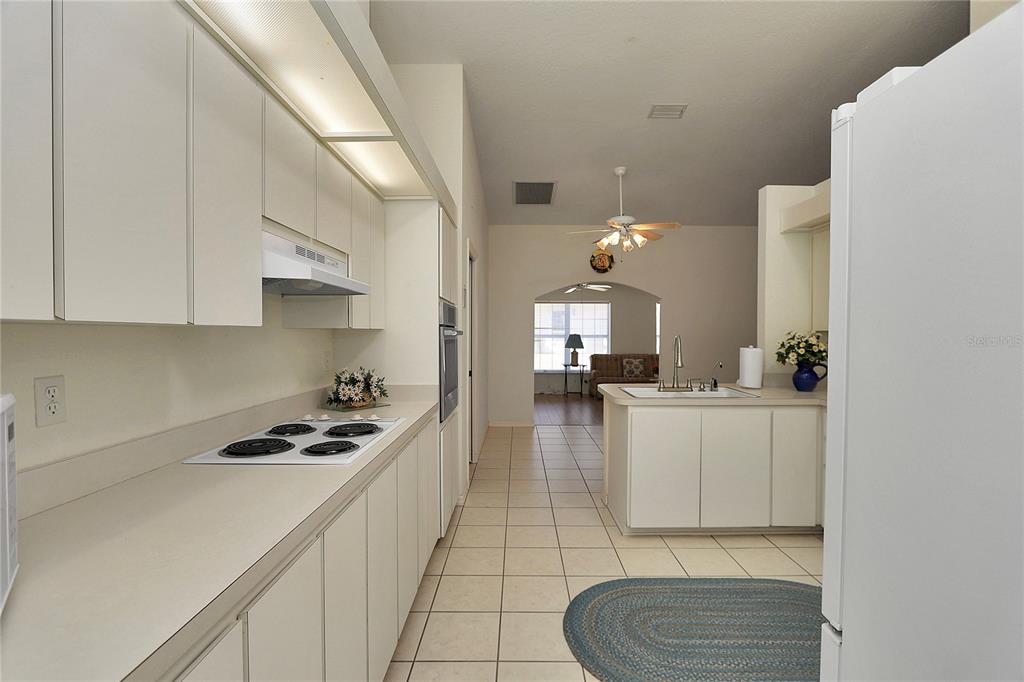 8319 Southwest 108th Loop Ocala, FL 34481 - Photo 9 of 27 a kitchen with white cabinets and appliances