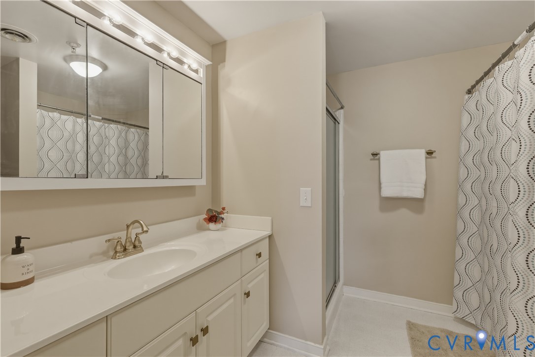 301 Beacon Ridge Drive, Unit 109 Hopewell, VA 23860 - Photo 11 of 30 a bathroom with a sink and a mirror