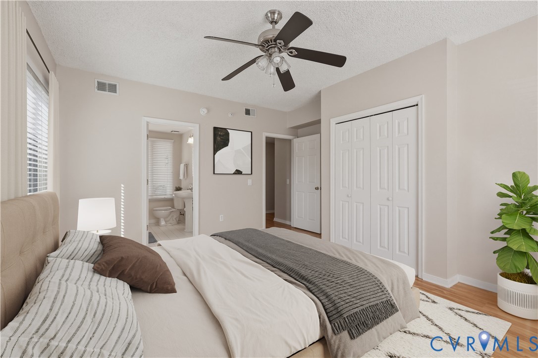 301 Beacon Ridge Drive, Unit 109 Hopewell, VA 23860 - Photo 12 of 30 a bedroom with a bed and a chandelier