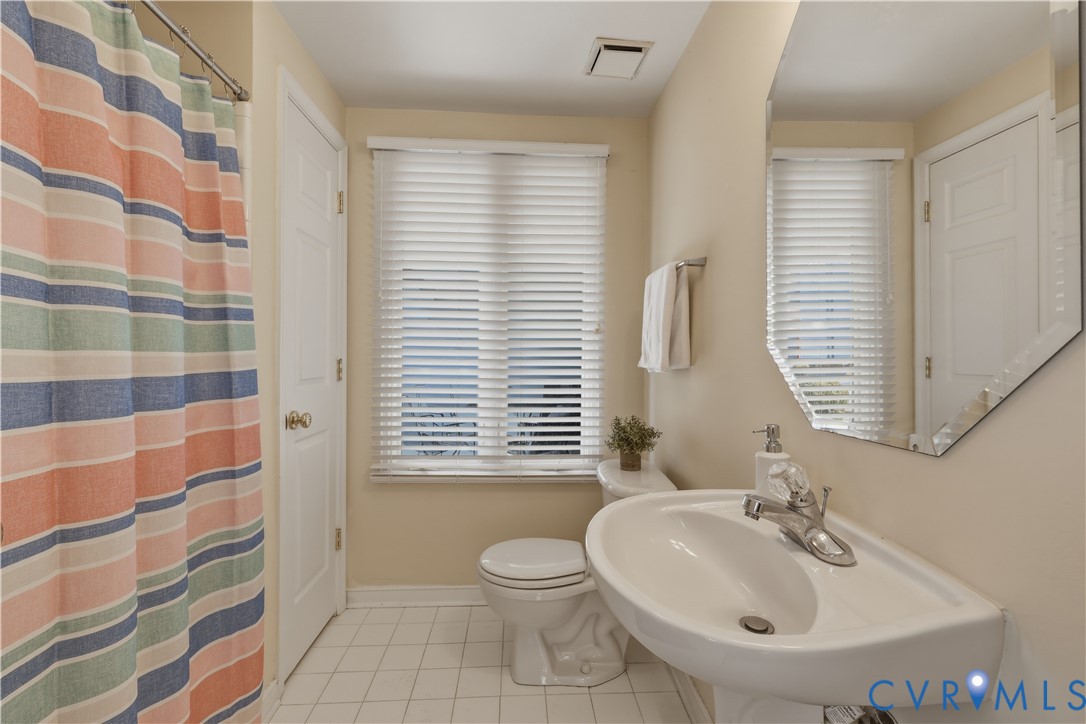301 Beacon Ridge Drive, Unit 109 Hopewell, VA 23860 - Photo 14 of 30 a bathroom with a sink a toilet and shower