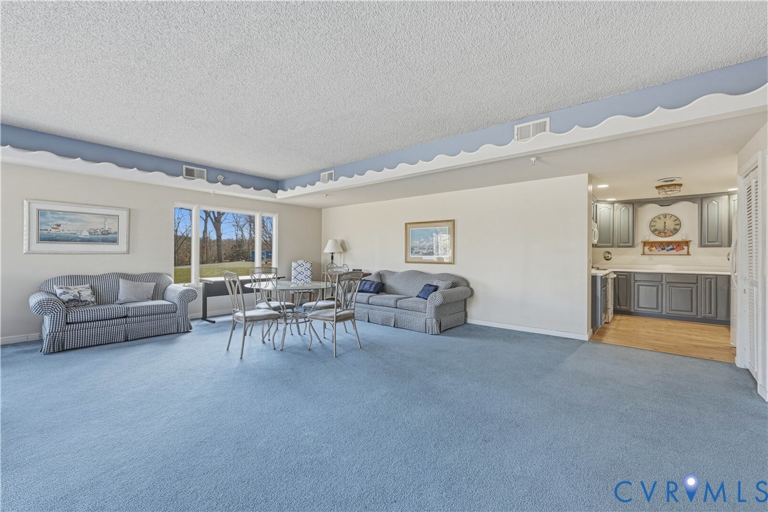 301 Beacon Ridge Drive, Unit 109 Hopewell, VA 23860 - Photo 25 of 30 a living room with furniture and a flat screen tv