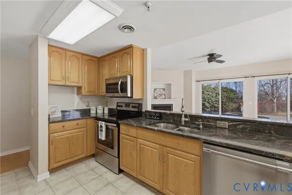 a kitchen with a sink stove and microwave
