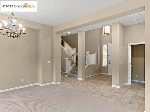 an empty room with windows and entryway