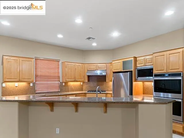 a kitchen with counter top space a sink and appliances