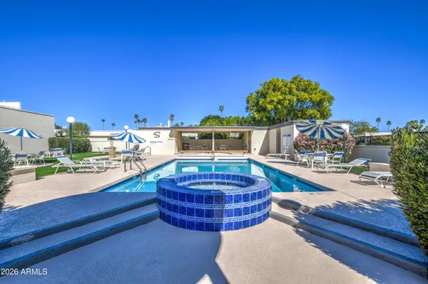 a view of a swimming pool with outdoor seating