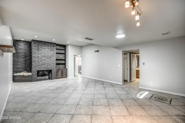 an empty room with windows and entrance