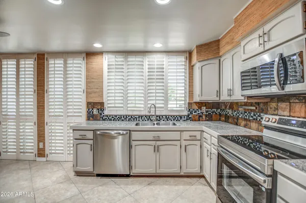 a kitchen with refrigerator cabinets and stainless steel appliances