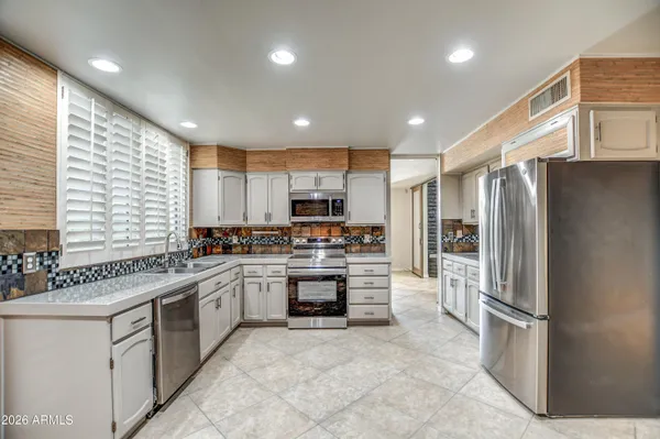 a bathroom with a granite countertop toilet sink and mirror