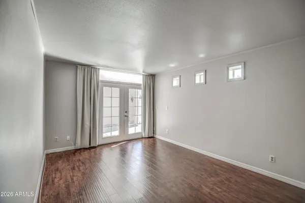 a living room with furniture a flat screen tv and a large window