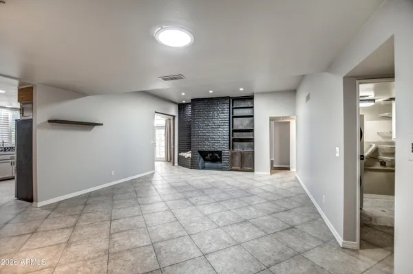 an empty room with windows and closet