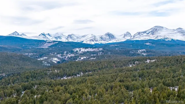 a view of a large building with mountains in the background