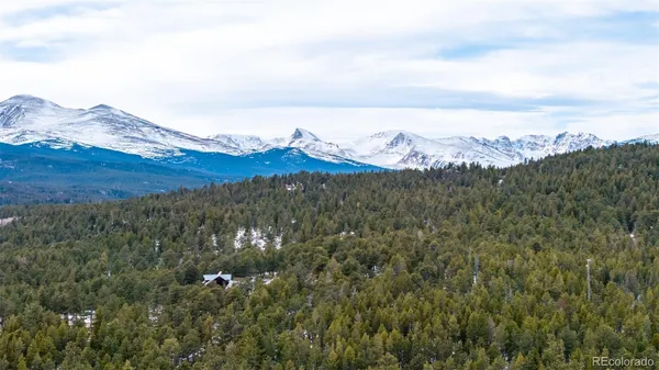 a view of a large mountain with a mountain in the background