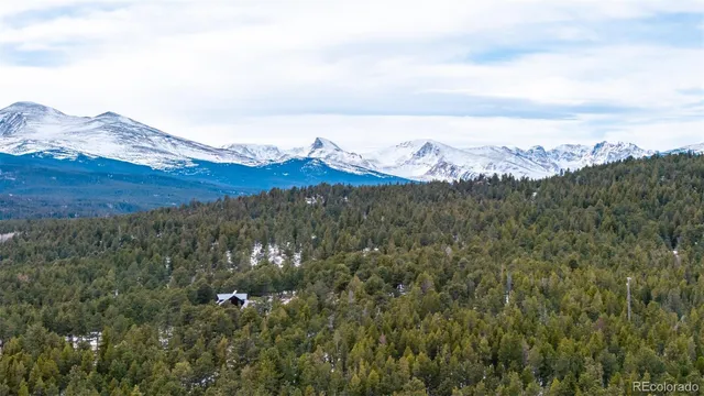 a view of a large mountain with a mountain in the background