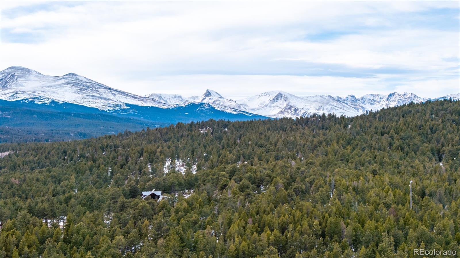 190 Hard Way Road Ward, CO 80481 - Photo 12 of 29 a view of a large building with mountains in the background